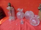 three glass vases sitting on a table with a red cloth