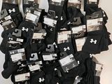 several pairs of black and white under armour socks are on display