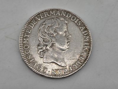 a close up of a coin on a white surface