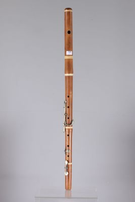 a close up of a wooden flute on a clear stand