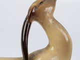 a statue of a bird that is sitting on a table