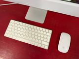 a computer monitor and keyboard on a desk with a mouse
