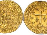 a gold coin with a cross on the front and a shield on the back