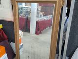 a mirror that is sitting on the floor in a room
