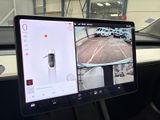 dashboard view of a car with two monitors on the dashboard