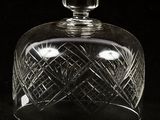 an image of a clear glass covered jar on a black surface