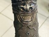 a wooden stick with a metal handle on a tile floor