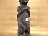 an image of a statue of a bear with a tag on it ' s chest
