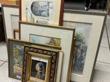 a lot of framed art on the floor in the room