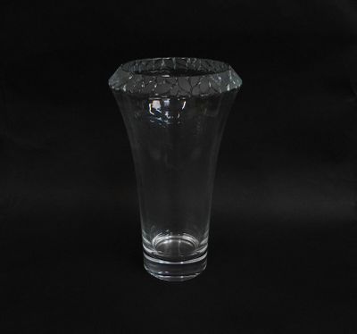 a glass vase that is sitting on a black background