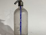 a clear glass bottle with a blue line on it