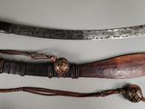 two different types of knives on display on a table