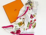 a scarf and a box on a white table