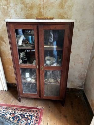 a wooden cabinet with glass doors in a room
