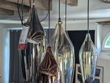 three glass lamps hanging from the ceiling in a room