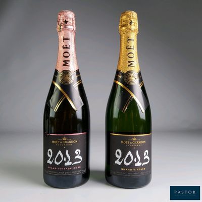 two bottles of champagne are shown next to each other on a table