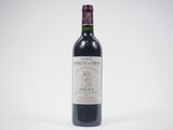 the bottle of red wine is sitting on the table