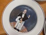 four plates with a painting of a man and a woman on them