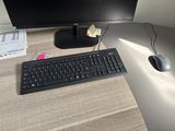 a computer monitor and keyboard sitting on a desk