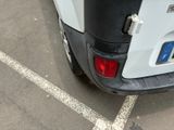 a small white truck parked in a parking lot