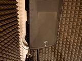a speaker that is sitting on a tripod in a room
