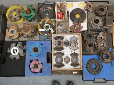 many different types of metal parts and tools on the floor