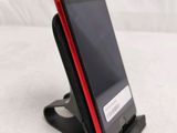 a cell phone that is on a stand on a bed