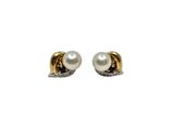 a pair of pearl and diamond earrings on a white background