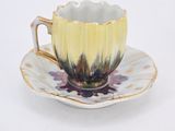 a cup and saucer on a saucer on a white table