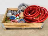 a wooden crate with a bunch of different types of hoses