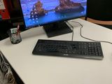 a computer desk with a keyboard and a monitor on it