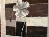 a painting of a flower in a vase hanging on a wall