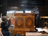 a woman that is standing in front of a cabinet