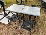 a table and chairs that are outside in the grass