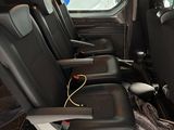 four seats in the back of a van that is empty