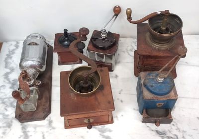de nombreux modèles différents de vieux moulins à café posés sur une table