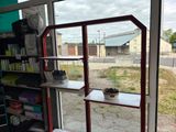 a window that has a potted plant on a shelf in front of it