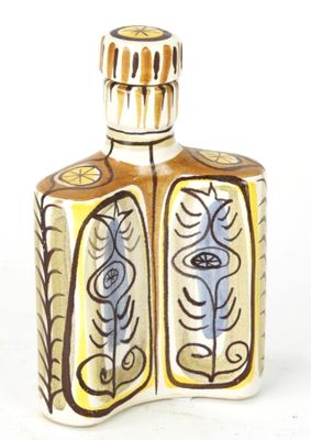 a small bottle with a flower design on it