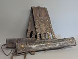 an old wooden chair with metal studding on it