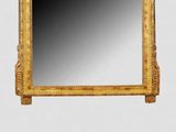 an image of a gold framed mirror on a wall