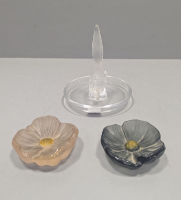 three small flower shaped dishes on a table
