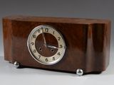 a wooden clock that is sitting on a table