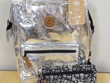 a silver backpack and a black and white purse on a table