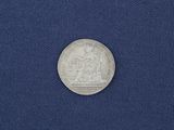 a close up of a silver coin on a blue cloth