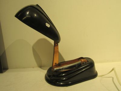 a black lamp that is sitting on a white table