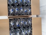 two cardboard boxes filled with bottles of water sitting on top of a floor