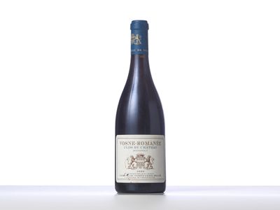 a bottle of wine sitting on top of a white table