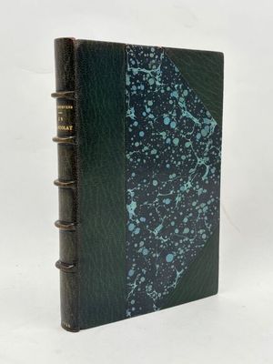un livre noir avec une couverture verte et un motif bleu