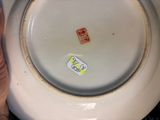 someone is holding a white plate with a sticker on it