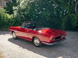 an image of a red convertible car parked in a driveway